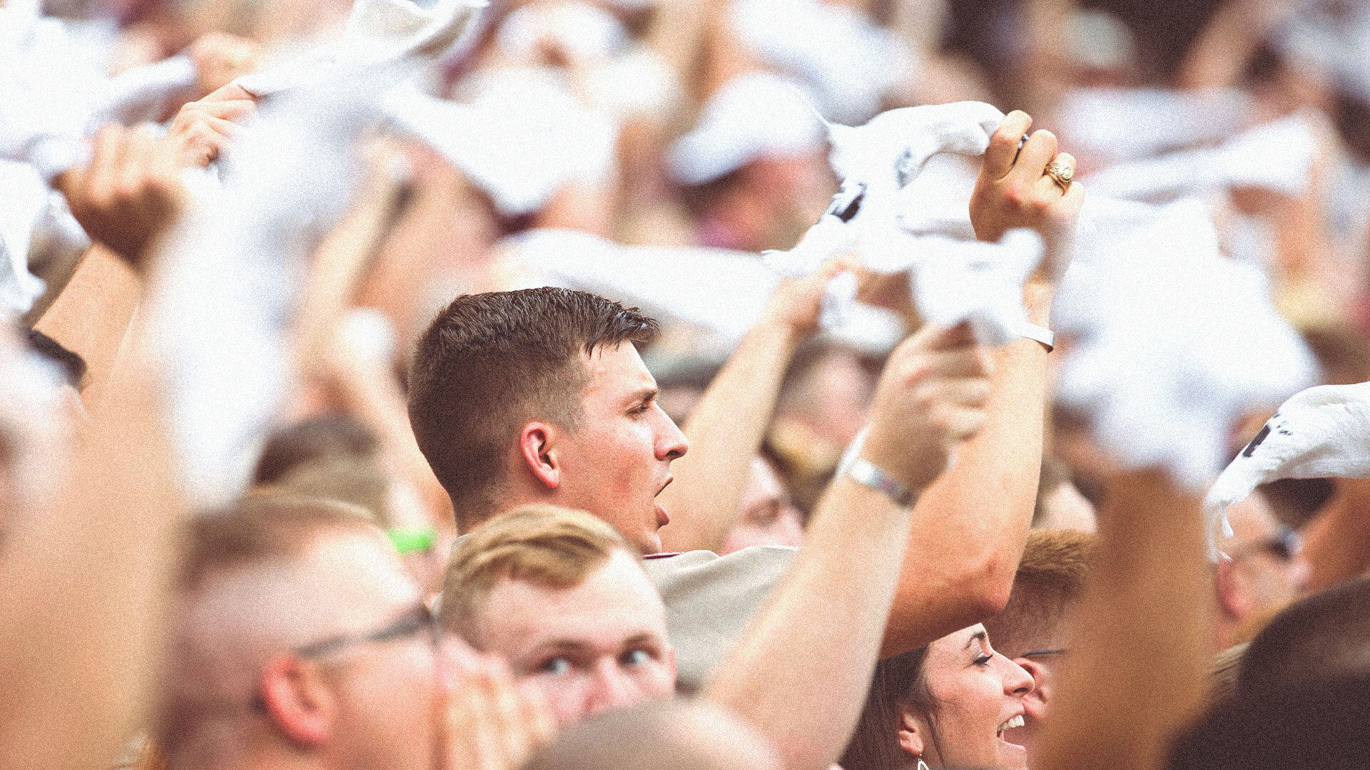 fans with towels waving in stadium